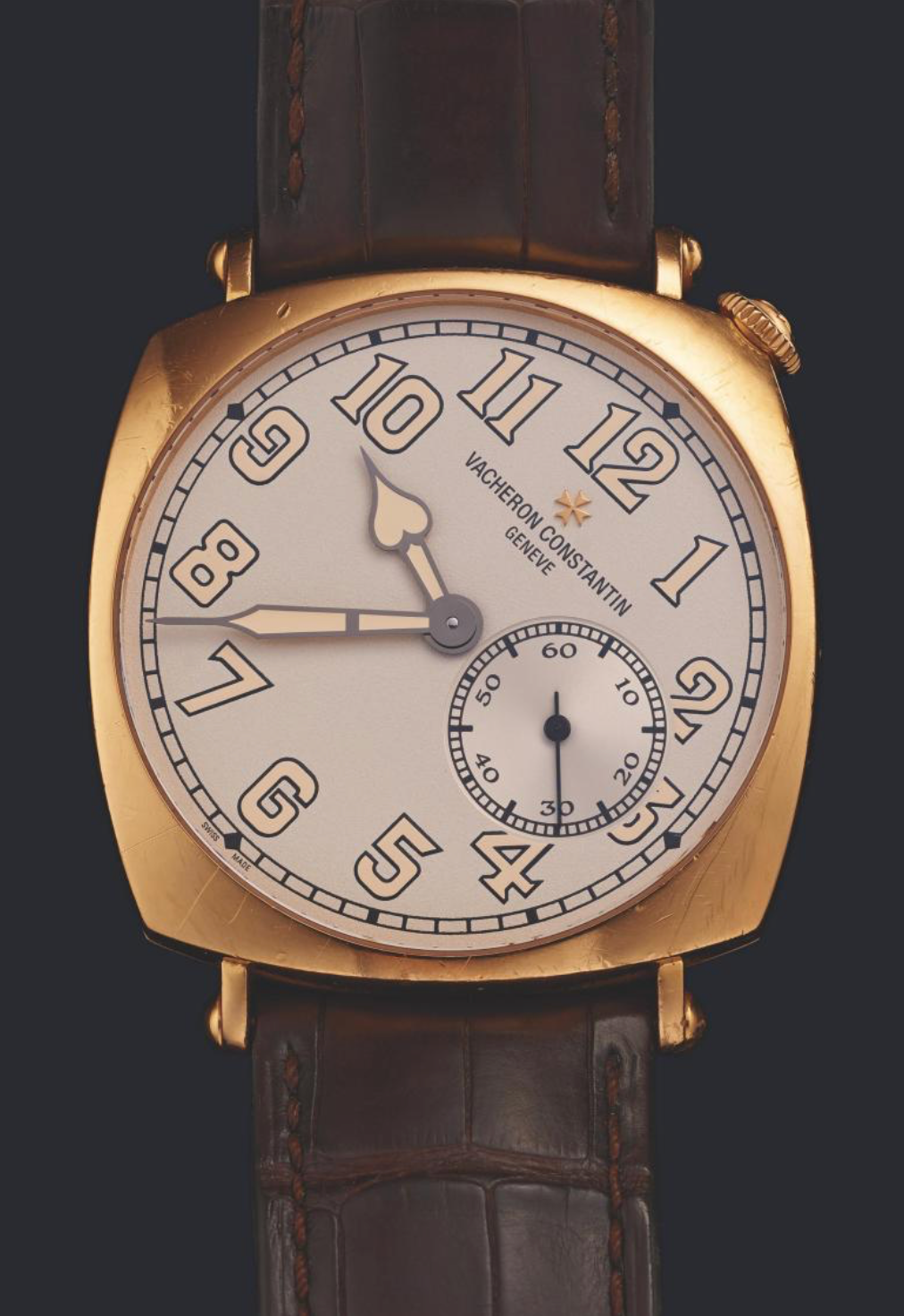 Vacheron Constantin watch with gold case and brown leather strap on a dark background