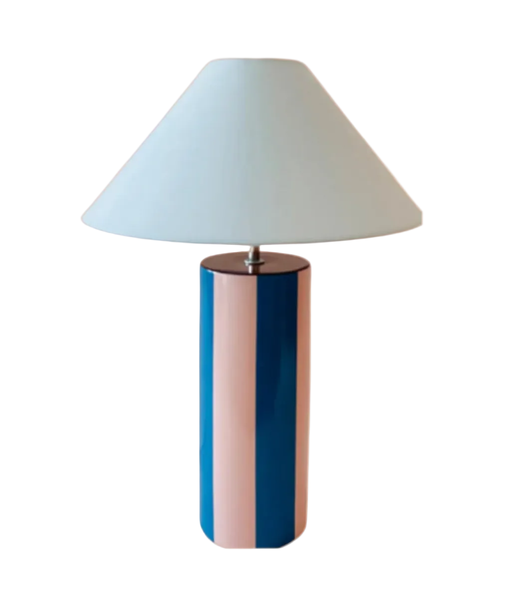 Table lamp with a blue cylindrical base and white conical shade on a white background