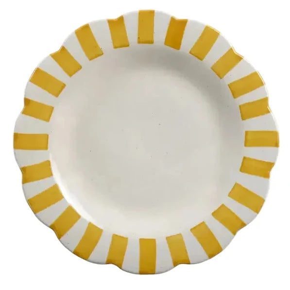 White plate with yellow stripes on a white background