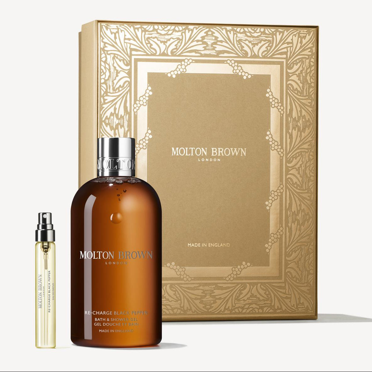 Molton Brown product set with a brown bottle and gold box on a white background