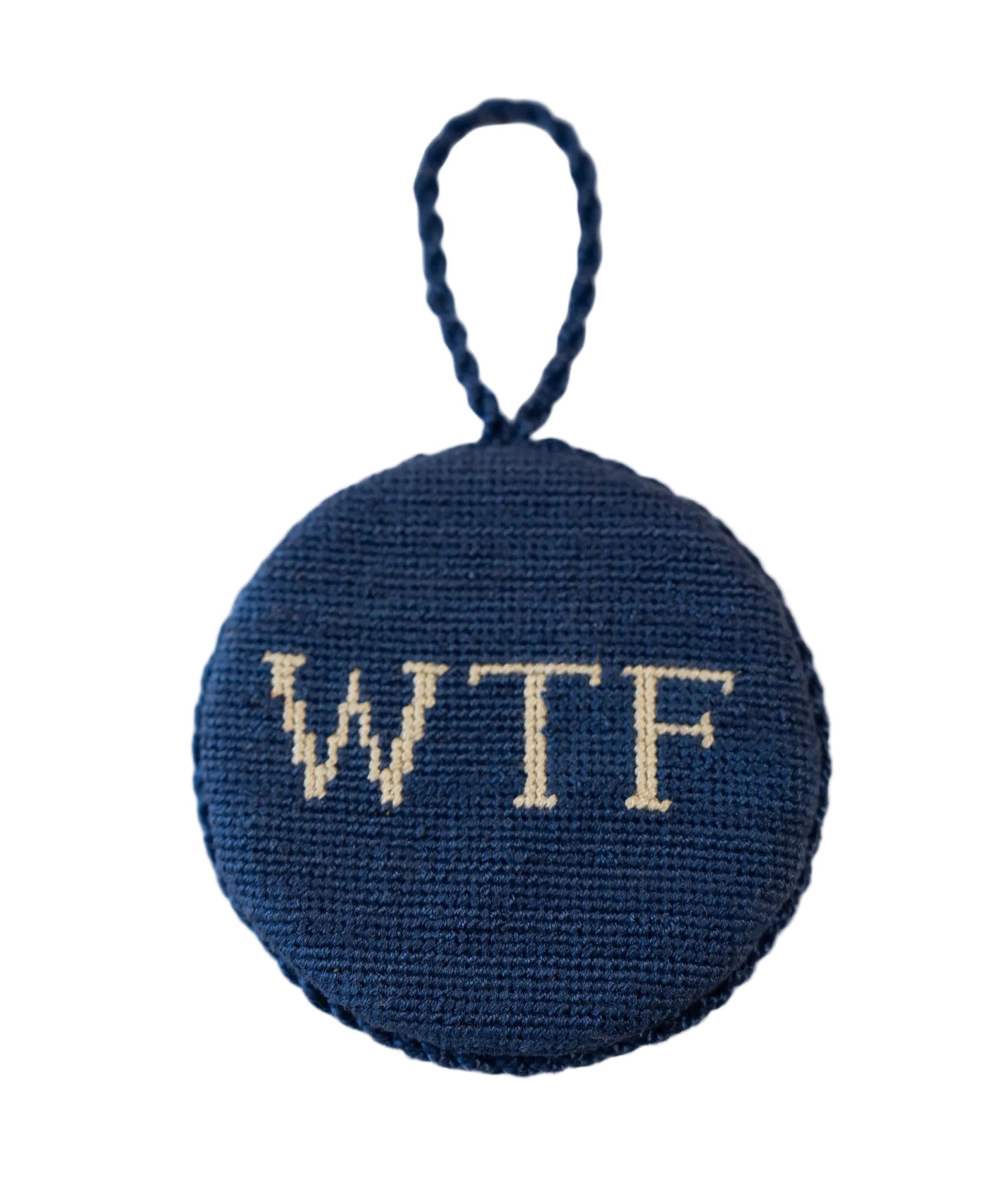 A round blue fairisle ornament with the text 'WTF' in the center.