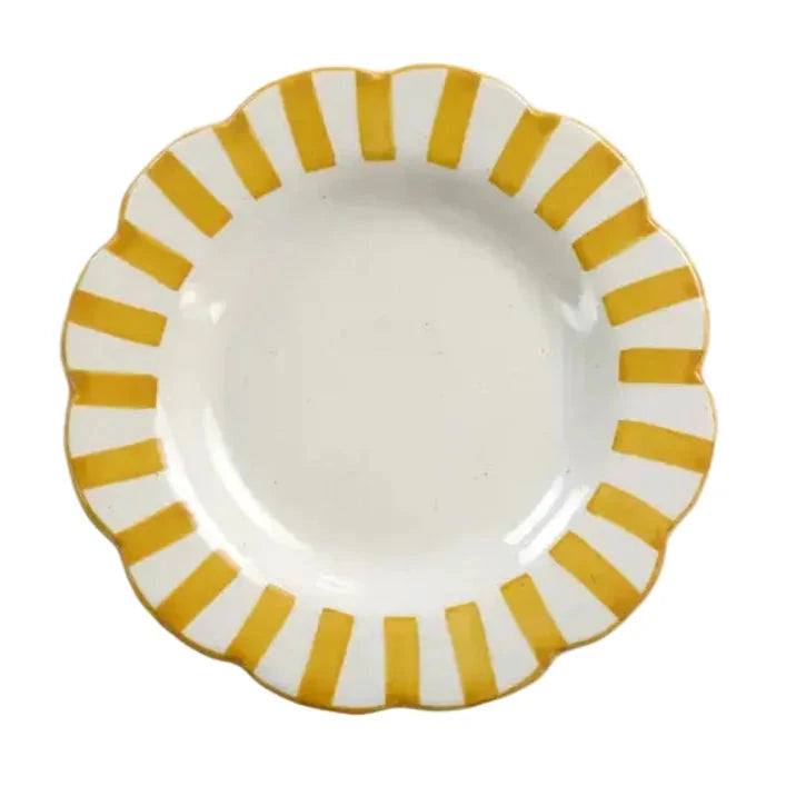 White plate with yellow striped rim on a white background