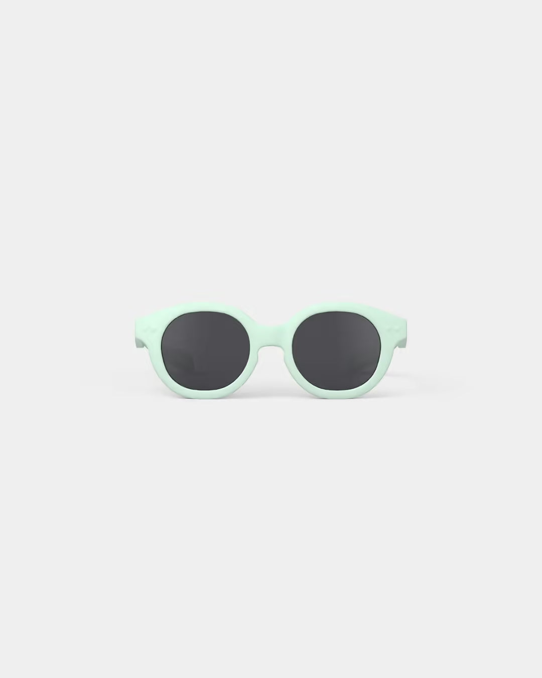 Mint green sunglasses with black lenses on a light gray background