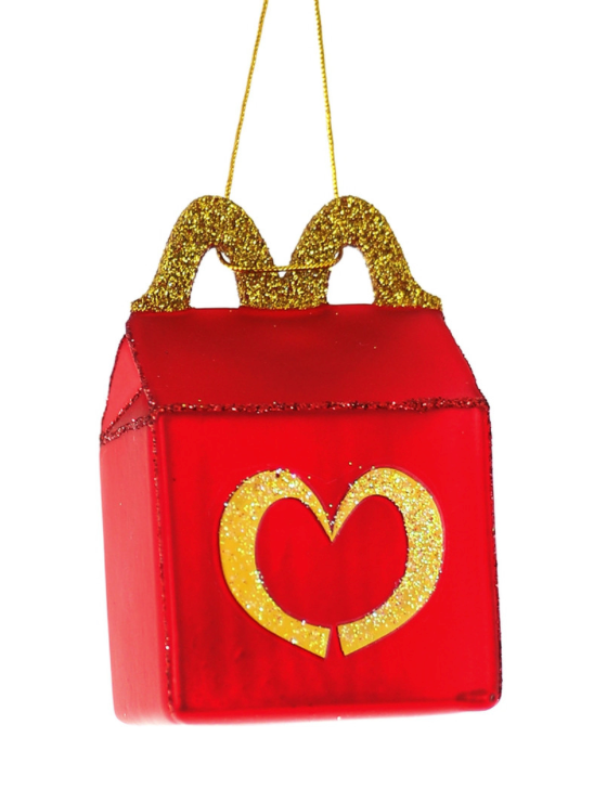 A red and gold glittery glass ornament designed to resemble a McDonald's happy meal box with a heart-shaped detail.