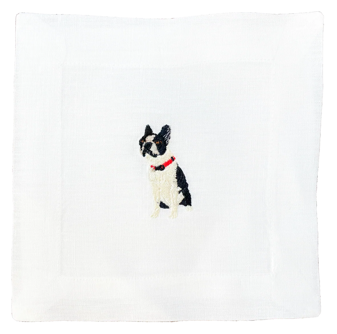 White napkin with a black and white dog illustration on a white background