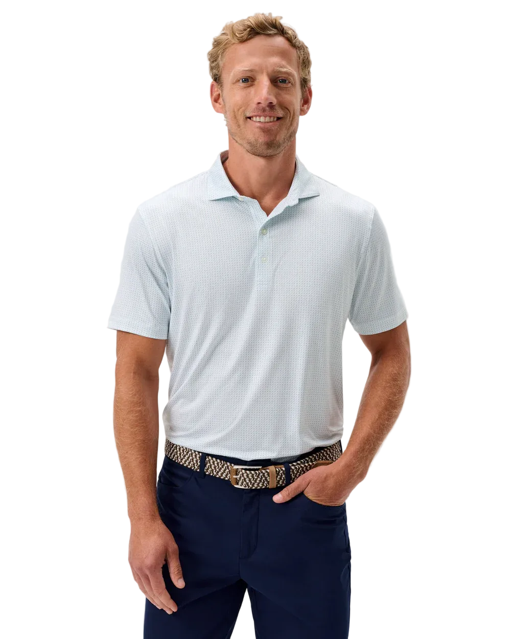 Man wearing a light blue polo shirt and navy pants on a plain background