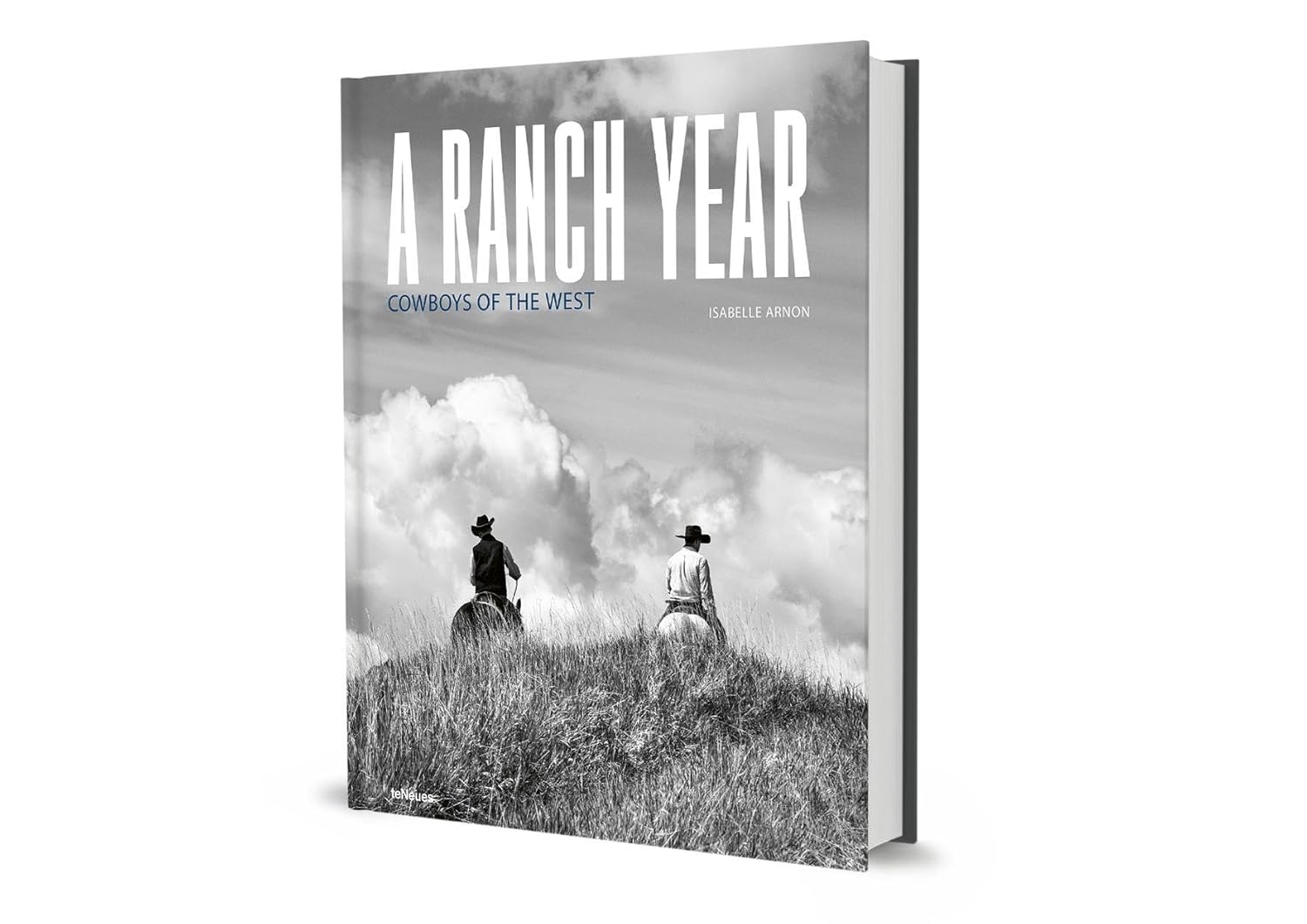Book titled 'A Ranch Year: Cowboys of the West' with a black and white cover featuring two people on a hill.