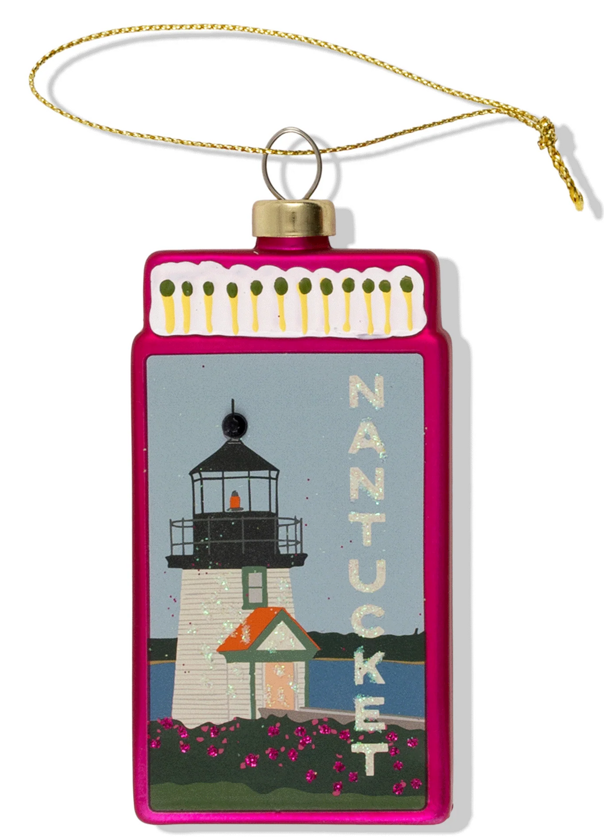 A decorative Christmas ornament shaped like a matchbook with a gold hanging string. The front features an illustrated lighthouse scene labeled 'NANTUCKET' on a white background.