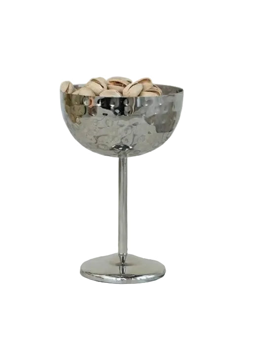 Silver bowl on a stand with decorative stones on a marble surface
