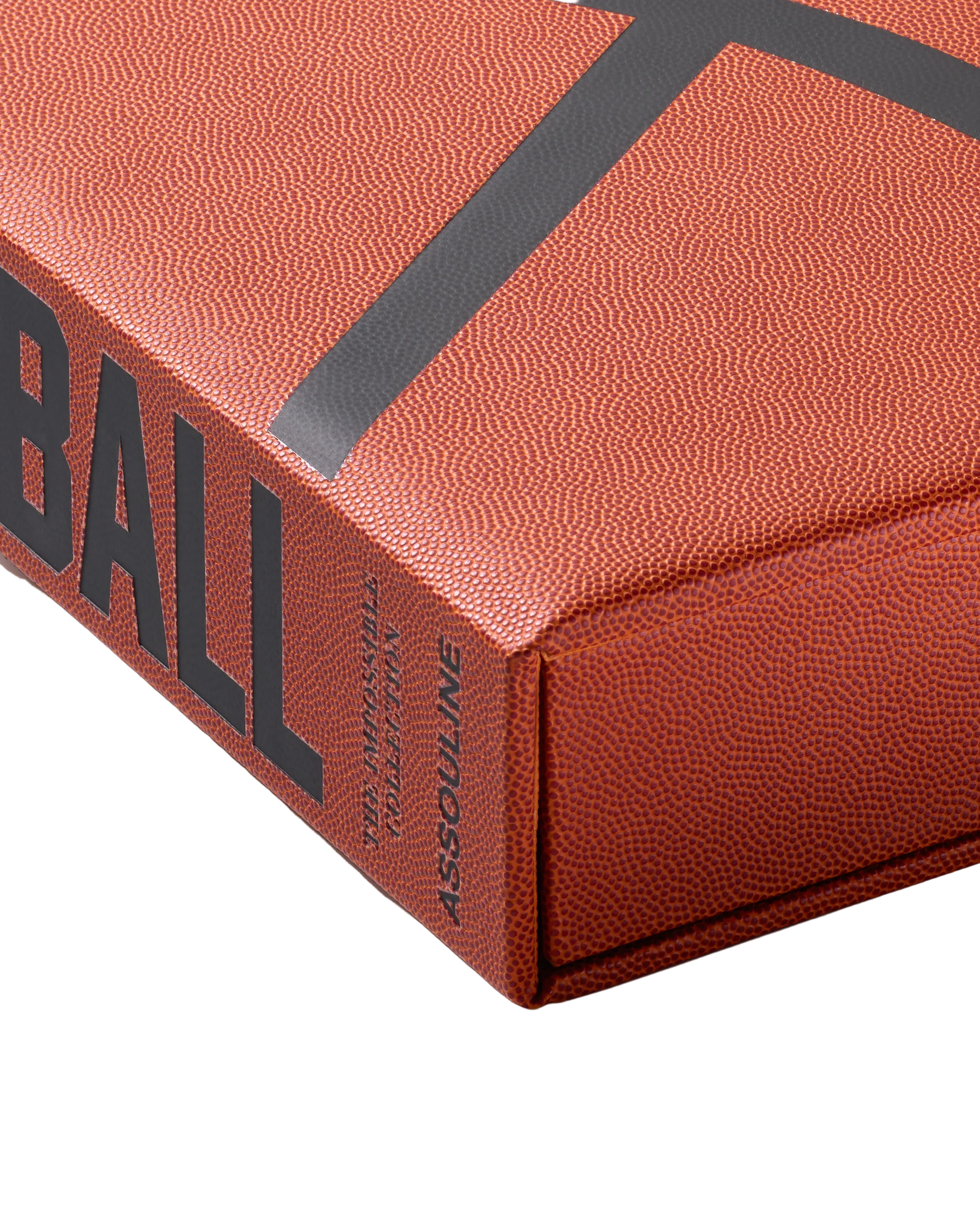 Close-up of a book with 'BALL' embossed on the cover, featuring Assouline branding.