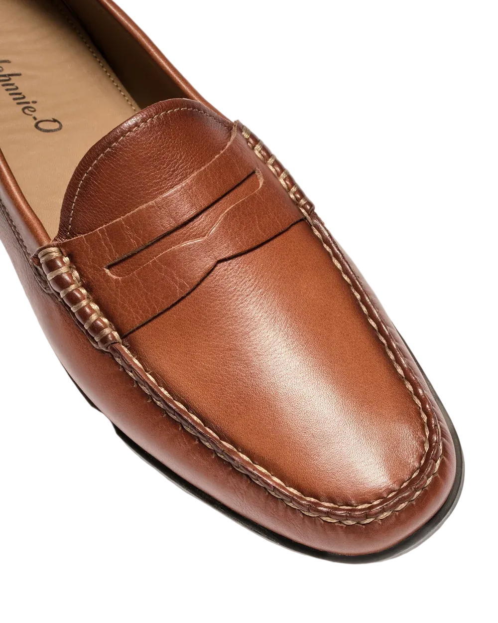 A close-up of a brown leather penny loafer with contrast stitching and a braided detail on the vamp, shown on a light gray background. The brand name 'Chambriard' is partially visible on the insole.