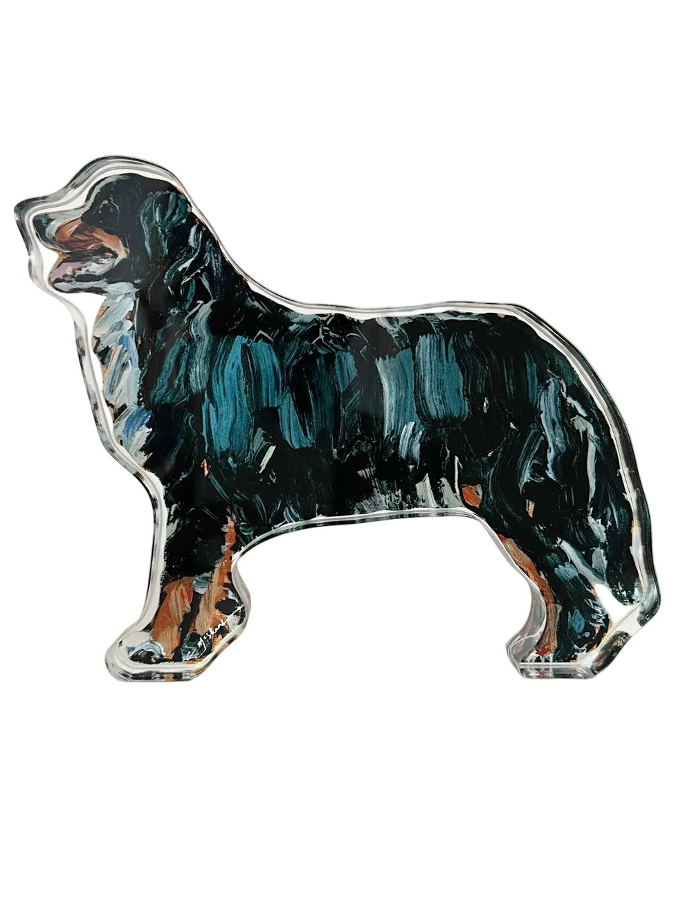 Dog-shaped ceramic magnet with black and brown design on a white background