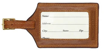Brown leather luggage tag with a white label for writing information on a white background