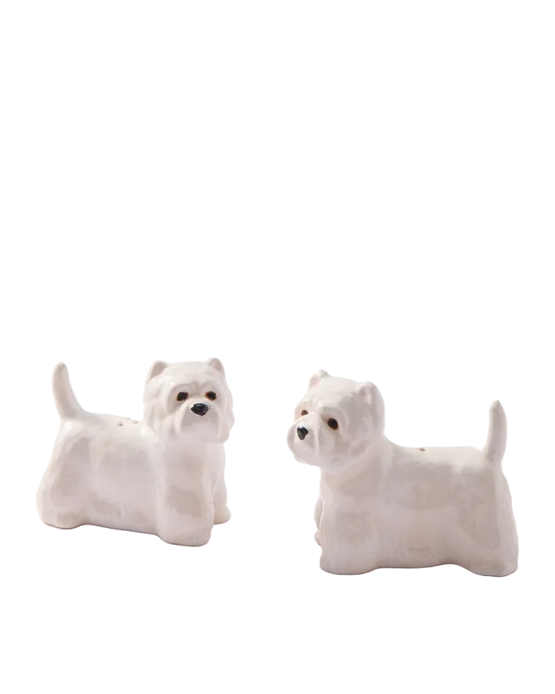 Two white dog-shaped salt and pepper shakers on a light gray background