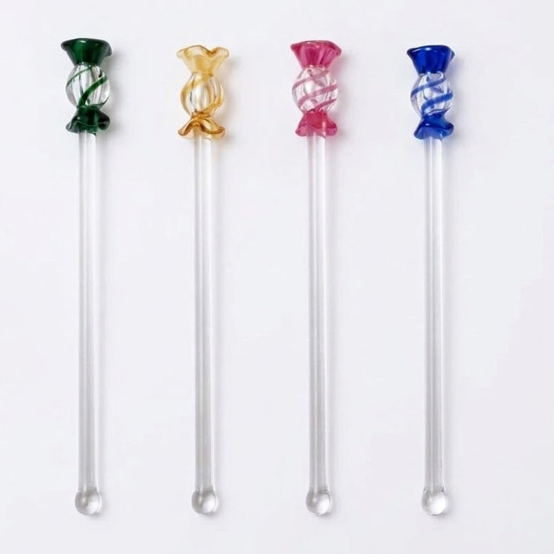 Set of colorful glass stir sticks on a white background