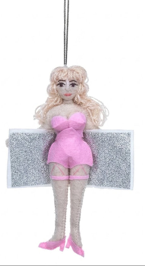 Decorative ornament of a blonde woman in pink outfit with a glittery platform on a white background