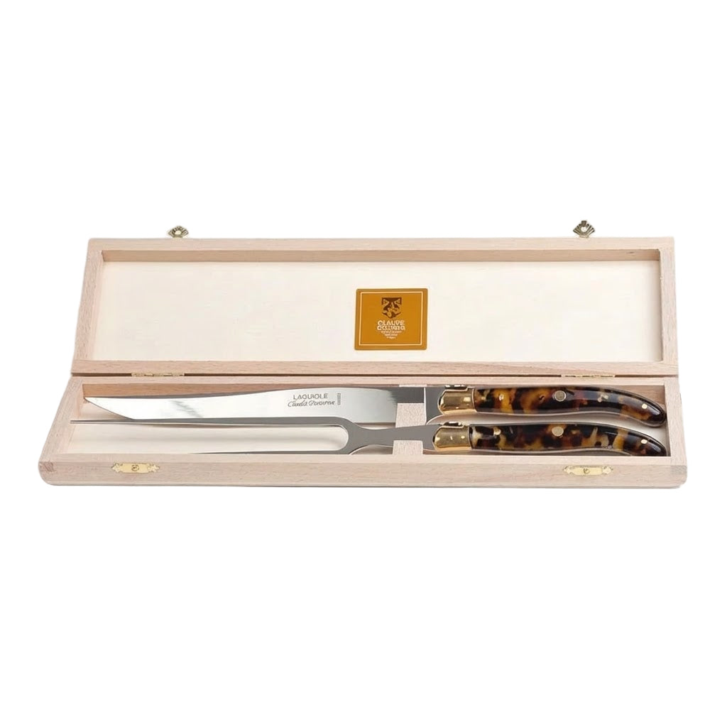 Set of carving knives with tortoiseshell handles in a wooden box on a white background
