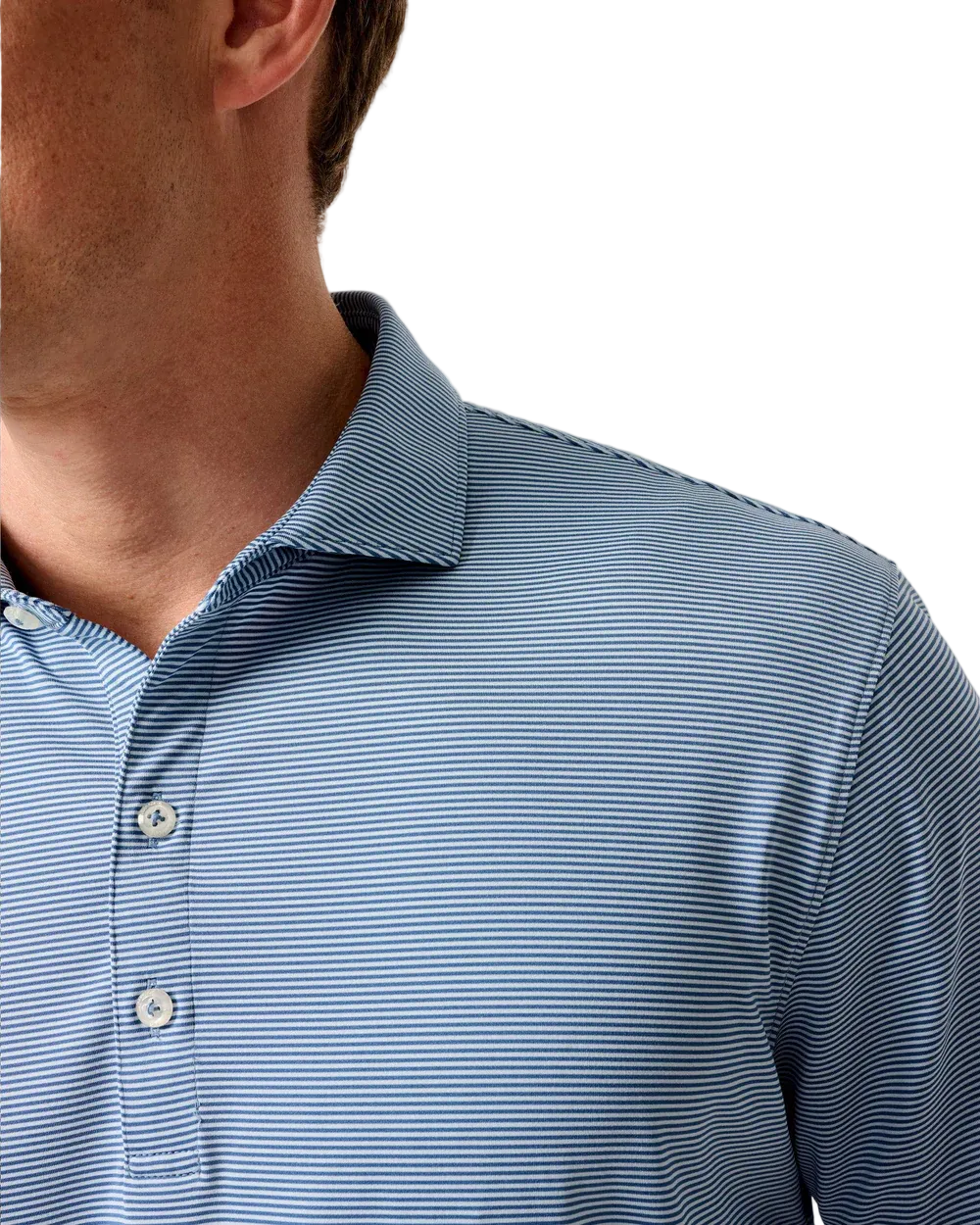 Close-up of a person wearing a blue striped polo shirt against a neutral background