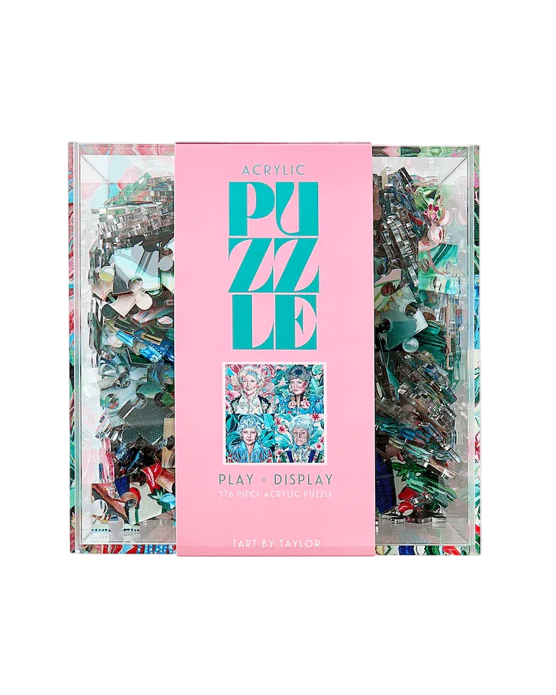 Puzzle box with colorful pieces and a pink cover on a white background