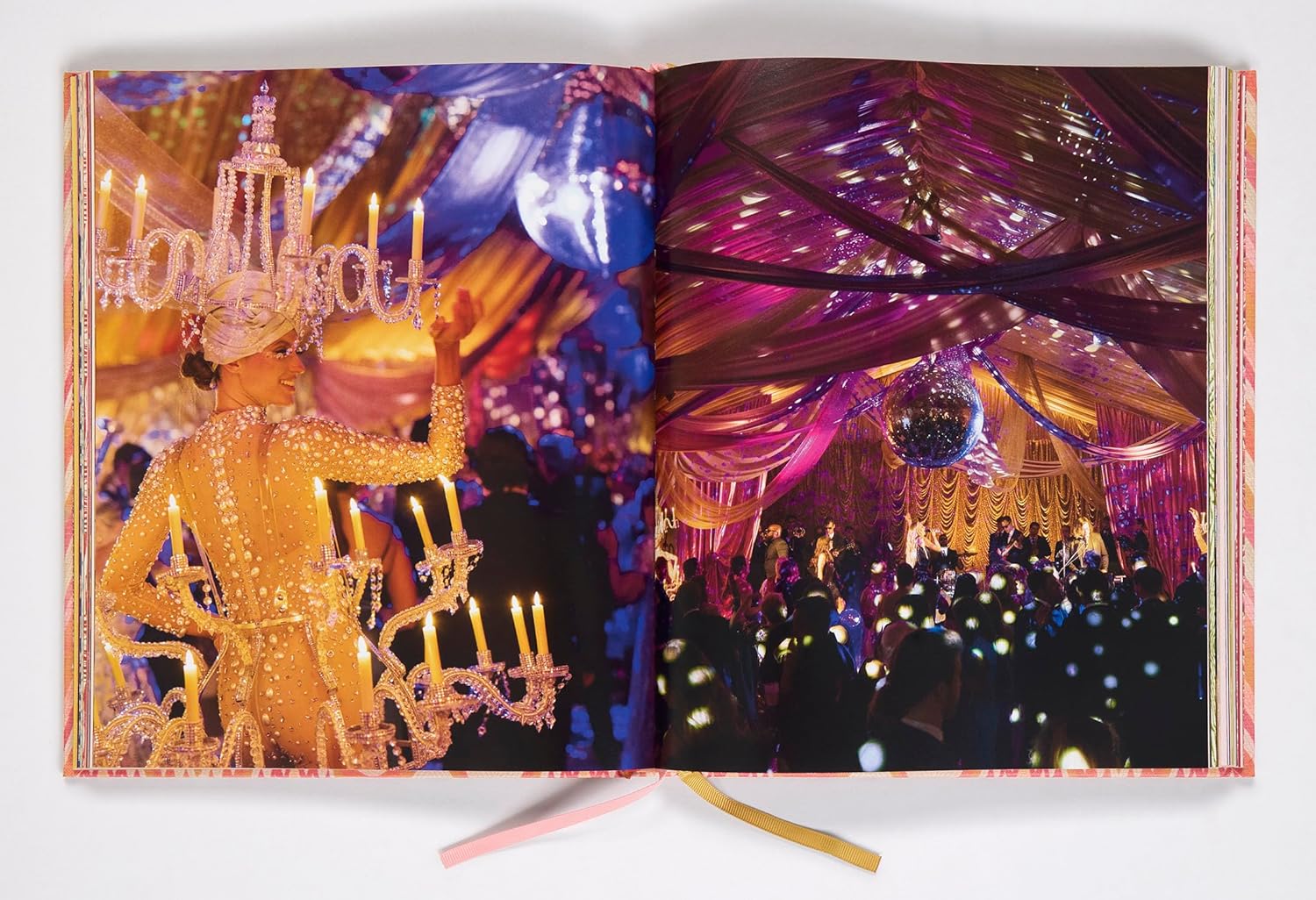 Book open to a page with a festive scene featuring a chandelier and colorful decorations.