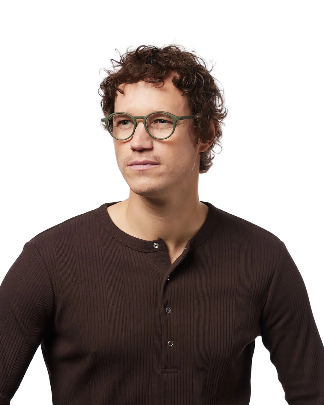 Man wearing a brown ribbed shirt and green glasses against a white background