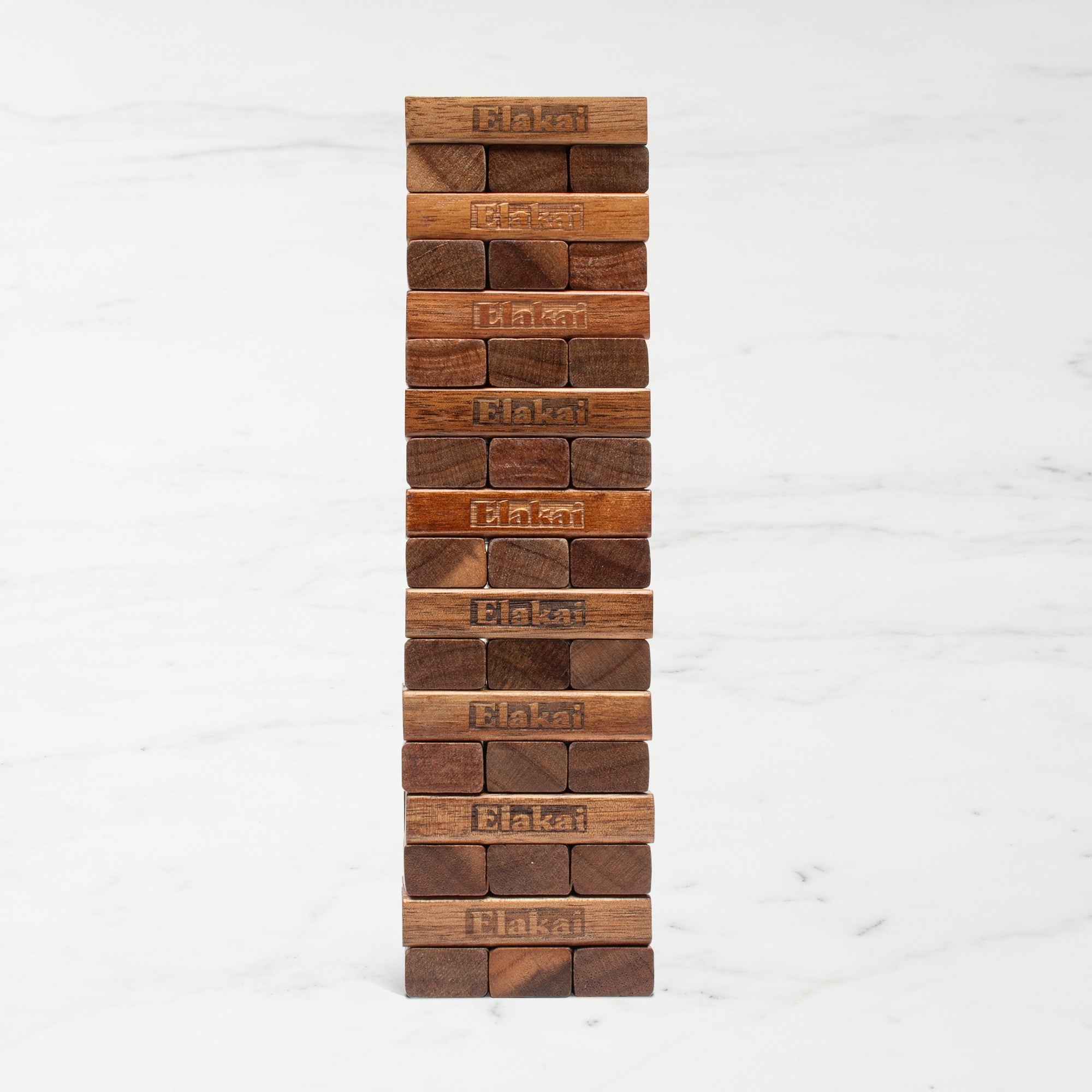 Stack of wooden blocks with 'Elakai branding on a white background