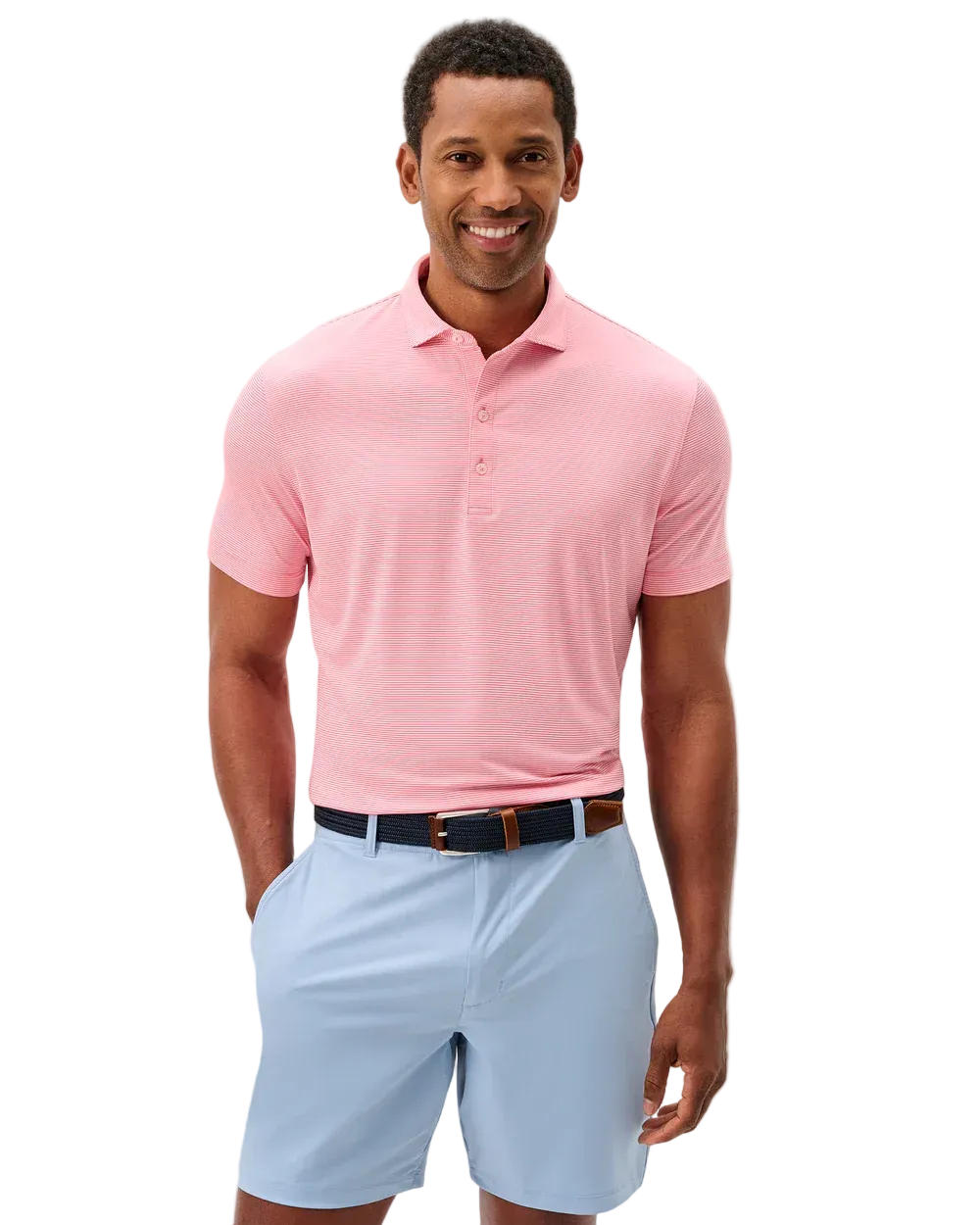 Man wearing a pink polo shirt and light blue shorts on a white background