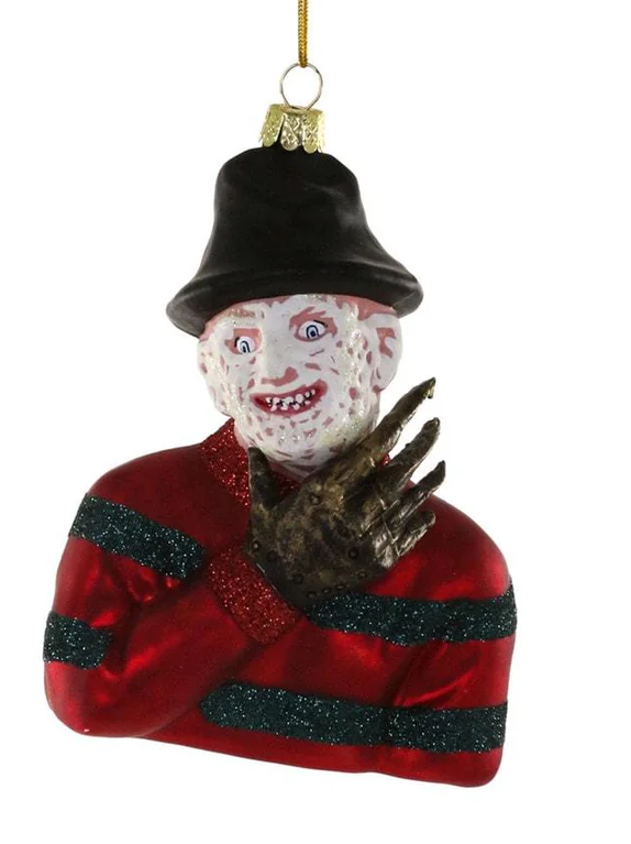 A horror-themed hanging ornament shaped like a man in a black hat and red striped jacket with glittery dark green stripes, holding a metallic clawed glove to his face. The ornament hangs from a gold string against a plain white background.