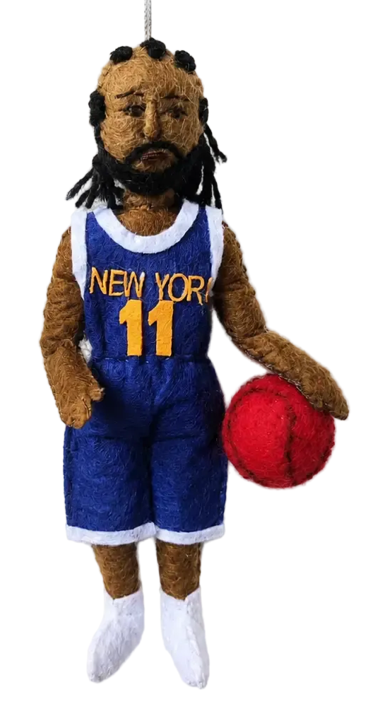 A felt Christmas ornament shaped like a basketball player with brown skin, black dreadlocks, and a beard, wearing a blue 'NEW YORK 11' jersey and holding a red ball, shown against a white background with a pine branch at the top.