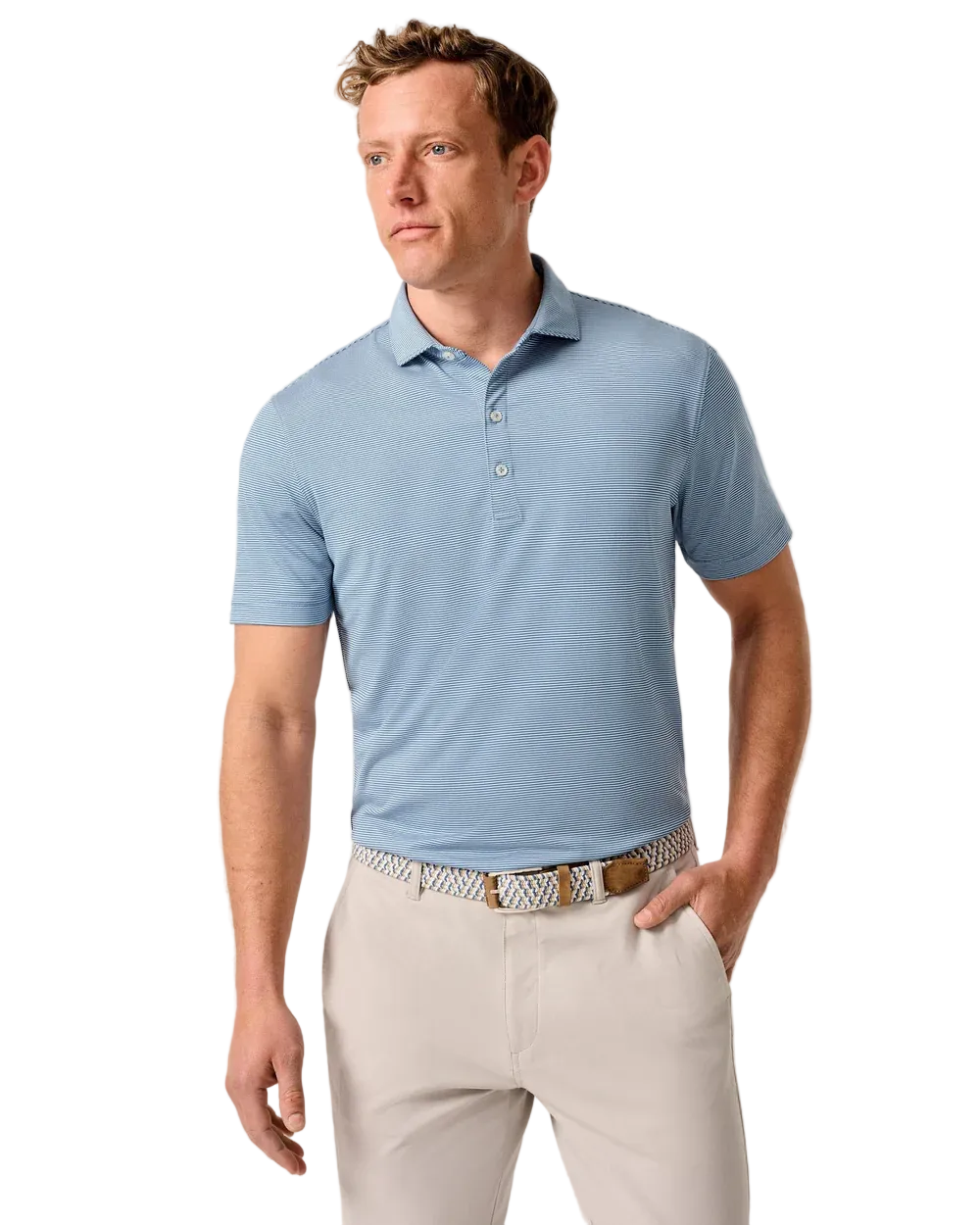 Man wearing a light blue polo shirt and beige pants against a neutral background