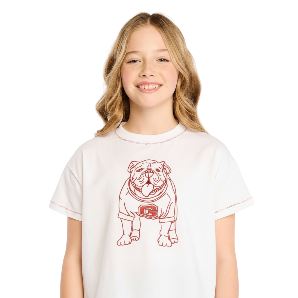 Young girl wearing a Miller Collective white t-shirt with a red embroidered bulldog graphic and contrast stitching.