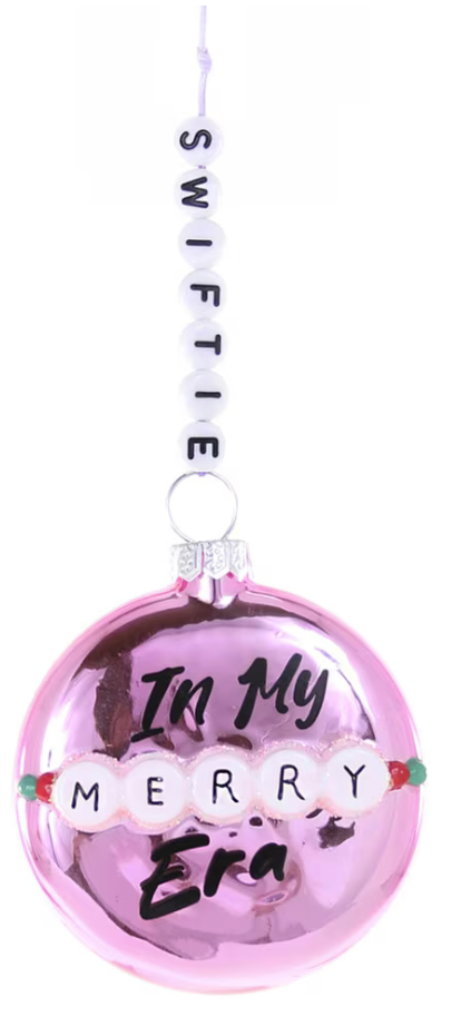Pink ornament with 'In My Merry Era' text and 'Swiftie' hanging above on a white background