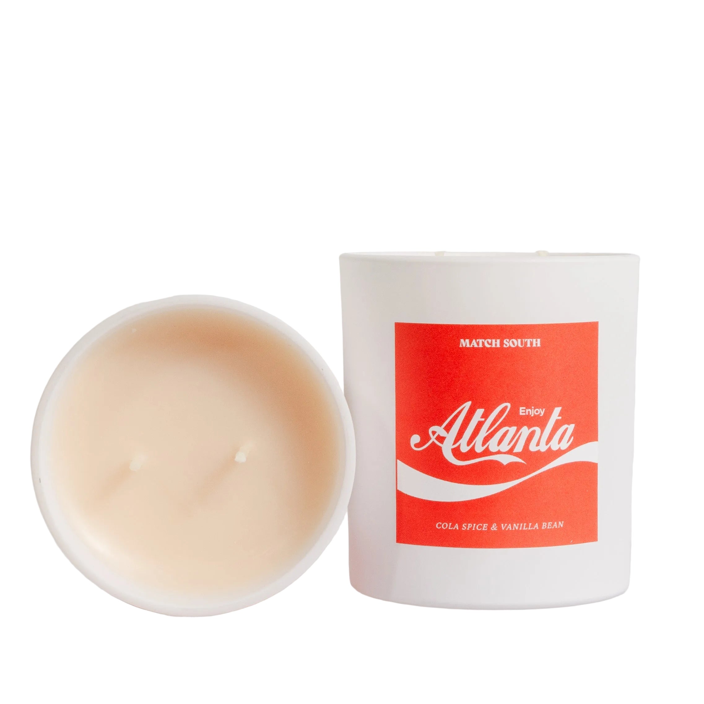 Candle and packaging with 'Enjoy Atlanta' branding on a light gray background