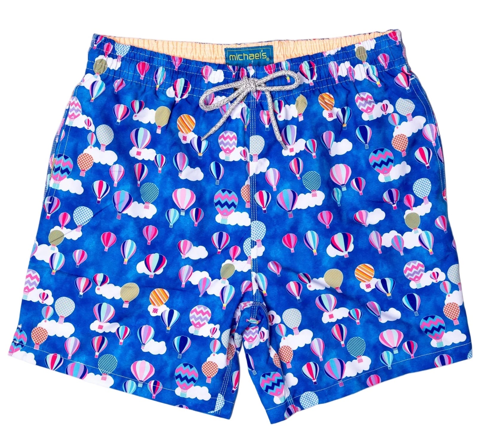 Blue swim shorts with colorful hot air balloon pattern on a white background