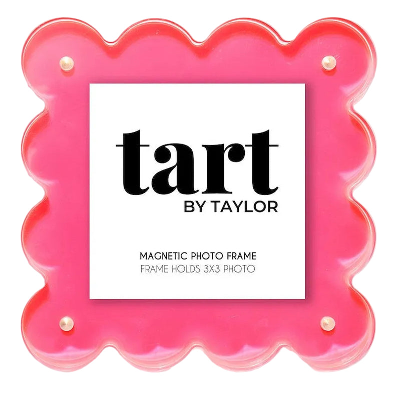 A scalloped hot pink acrylic magnetic photo frame by Tart by Taylor, featuring a white center insert with black text, set against a light gray background.