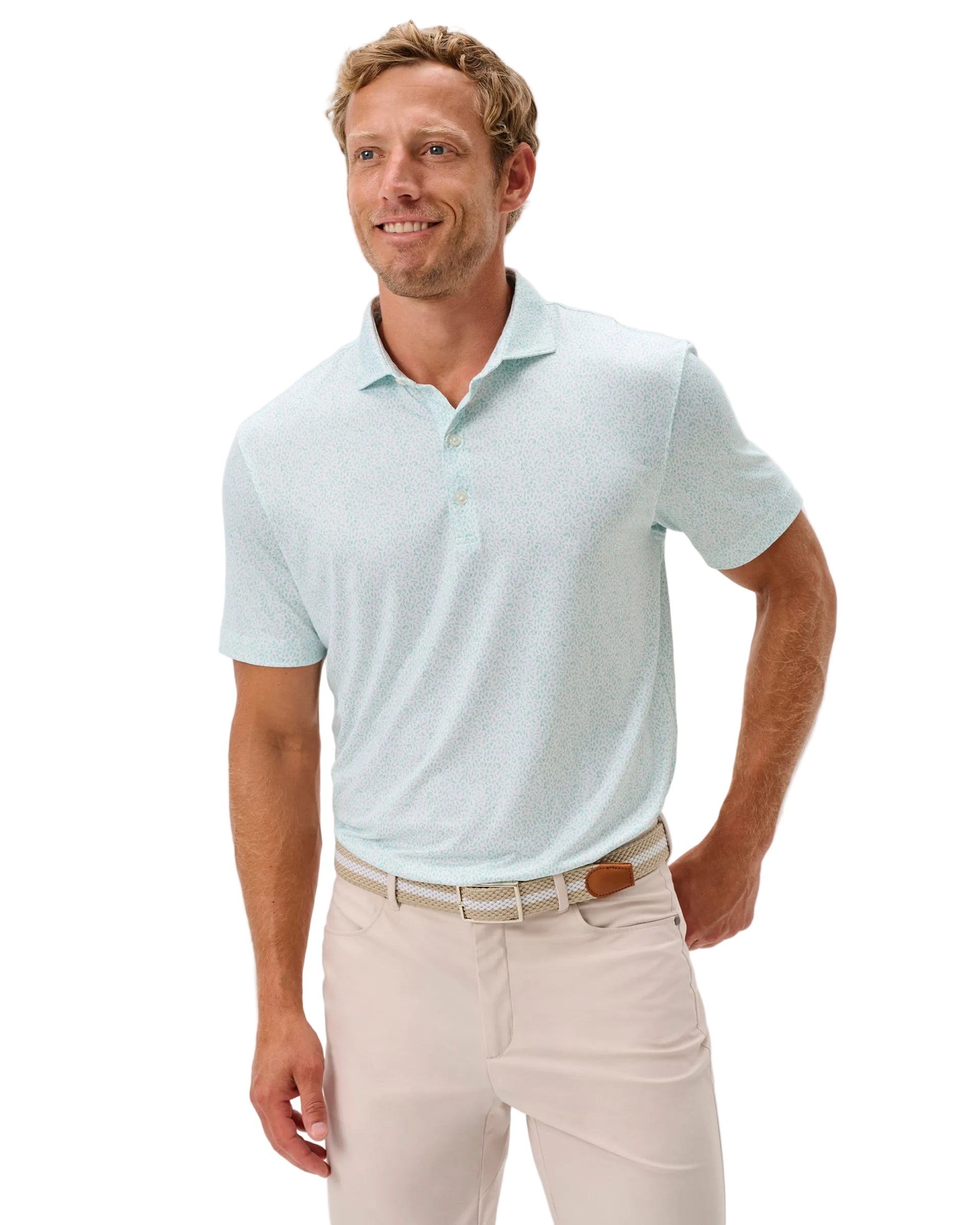 Man wearing a light blue polo shirt and beige pants on a white background