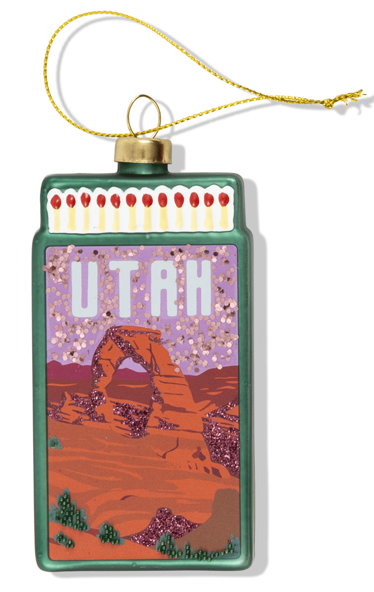 Decorative ornament shaped like a matchbook with 'Utah' and a desert scene design on a white background.