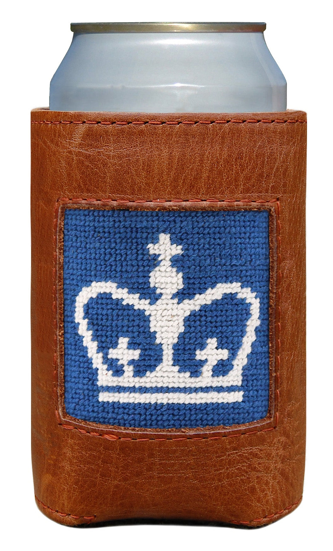 A brown leather can cooler sleeve holding a silver can, featuring a blue and white embroidered crown patch on the front, set against a plain white background.
