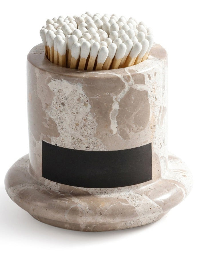 Marble-patterned matchbox holder with matches on a white background