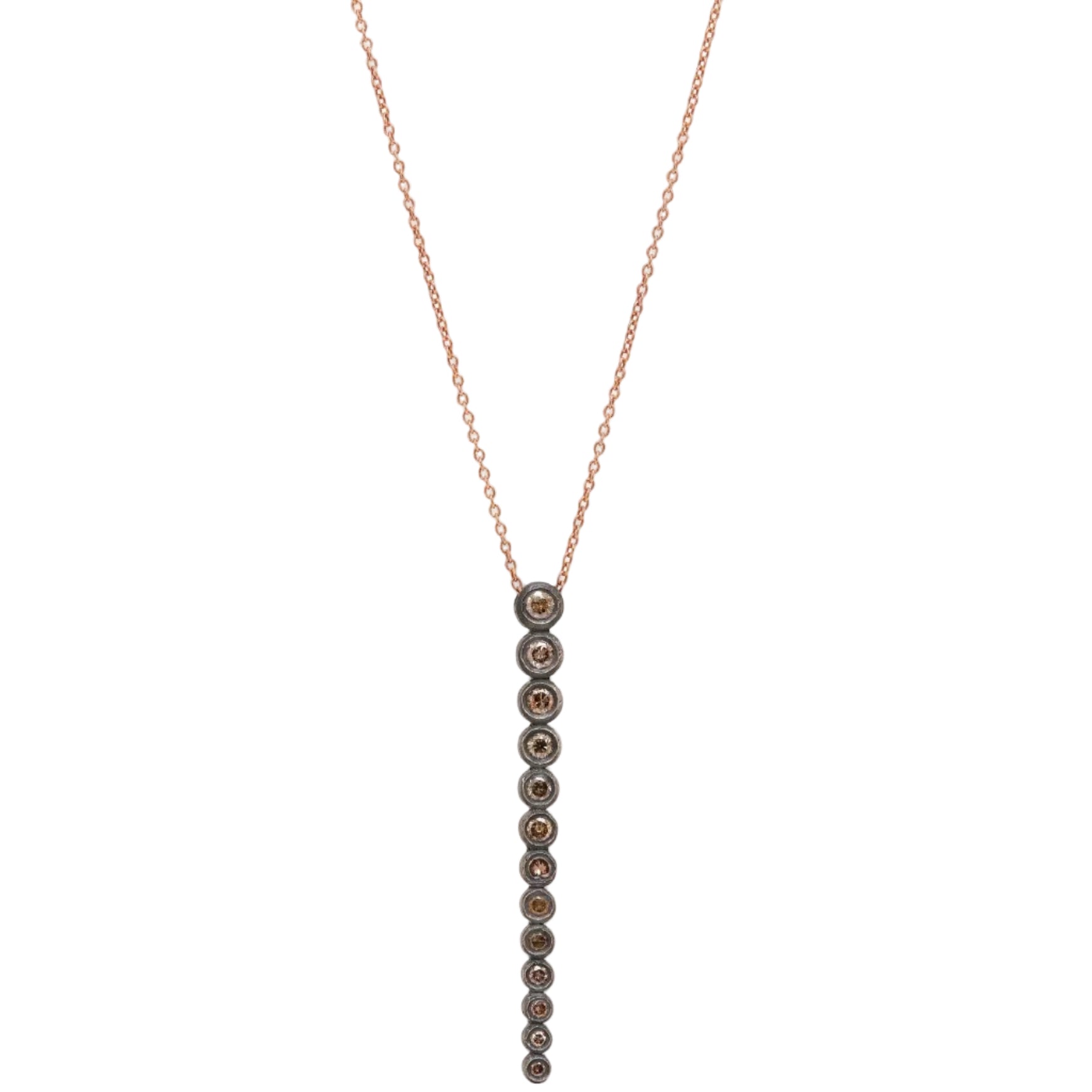 Necklace with small beads on a thin chain against a light background