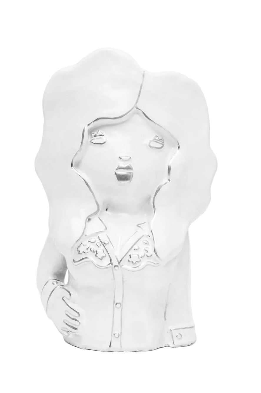 White ceramic vase shaped like a stylized face on a white background