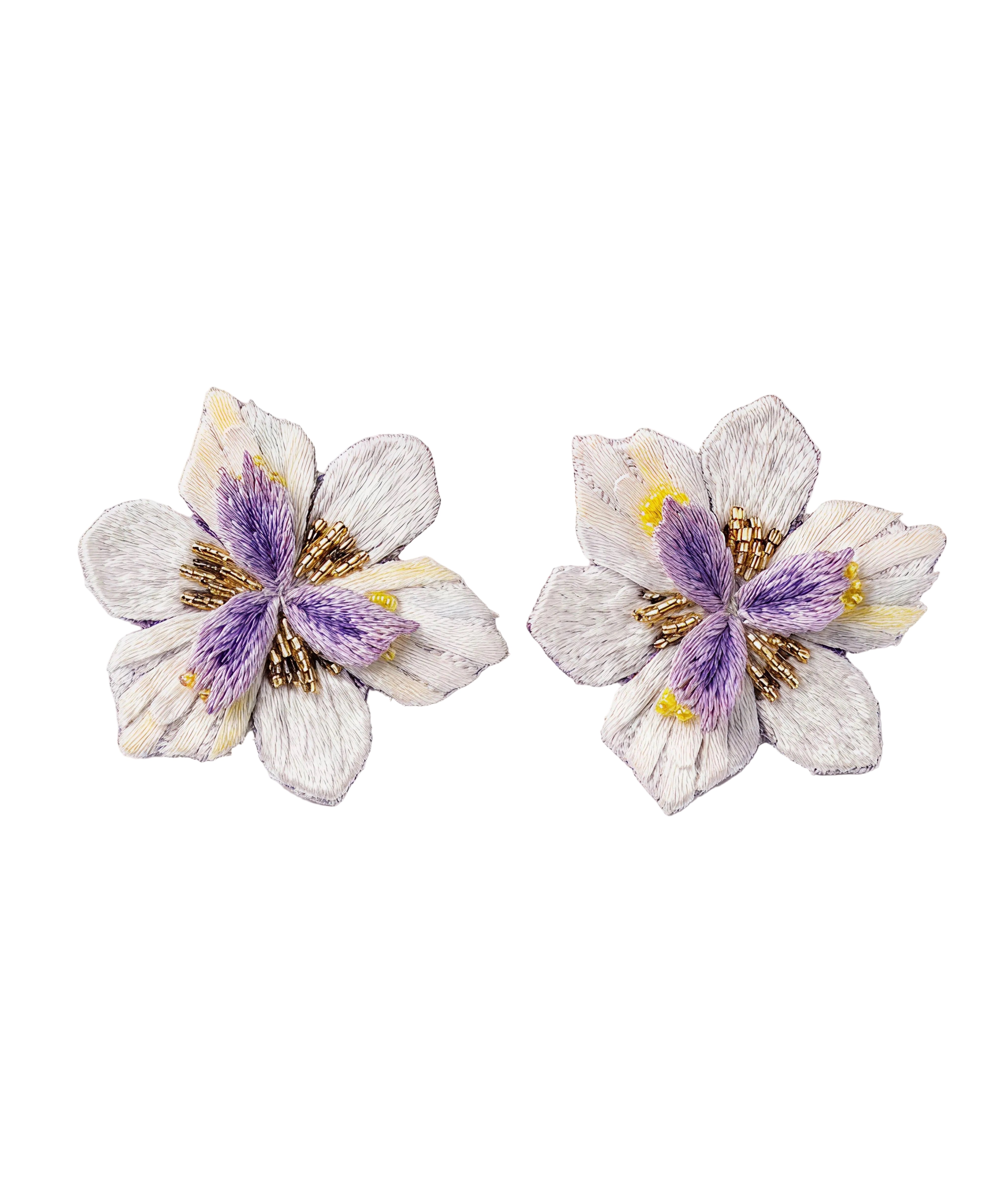 Pair of floral earrings with purple and gold centers on a light gray background