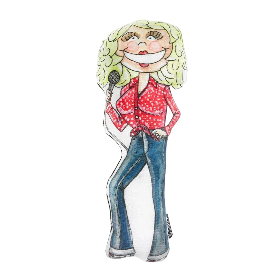 A cartoon-style illustrated figure with curly blonde hair, a wide smile, a red polka-dot blouse, blue jeans, and a microphone, shown on a plain white background.