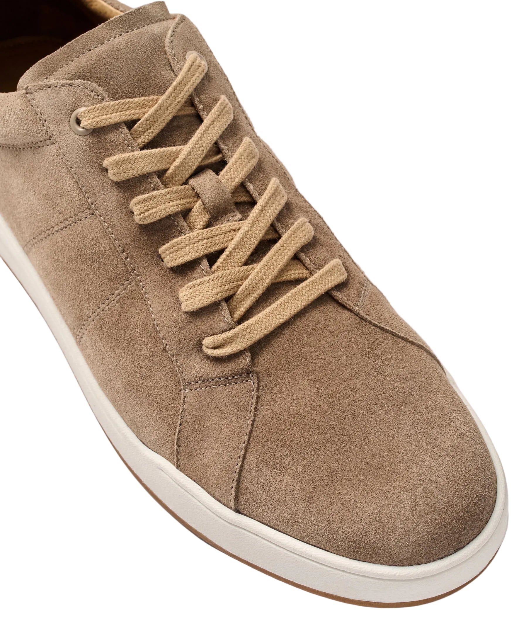 Brown suede sneaker with white sole on a light gray background