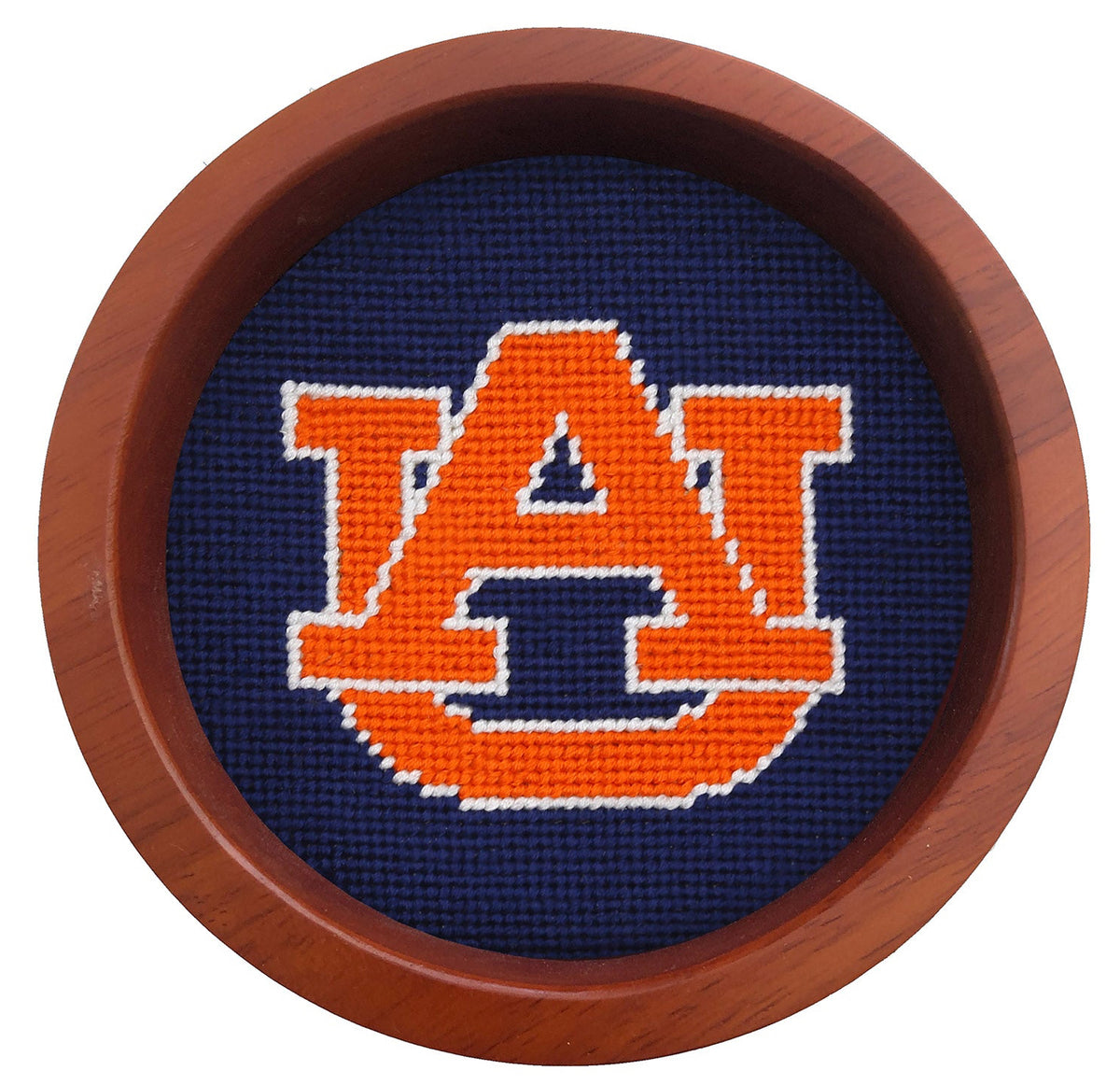 A circular wooden-framed needlepoint canvas featuring the Auburn Tigers 'AU' logo in orange and white on a dark navy blue background, shown against a plain white background.