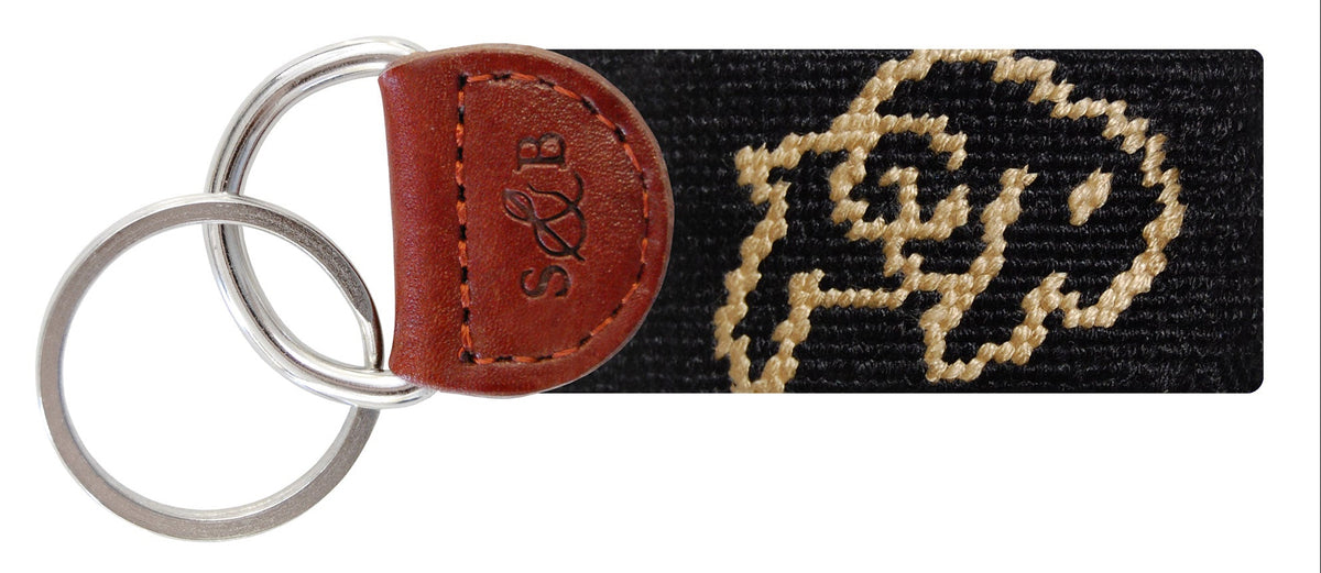 Keychain with needlepoint design and leather accent on a white background