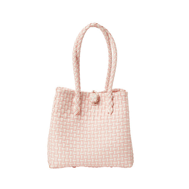 Pink woven handbag with rope handles on a white background
