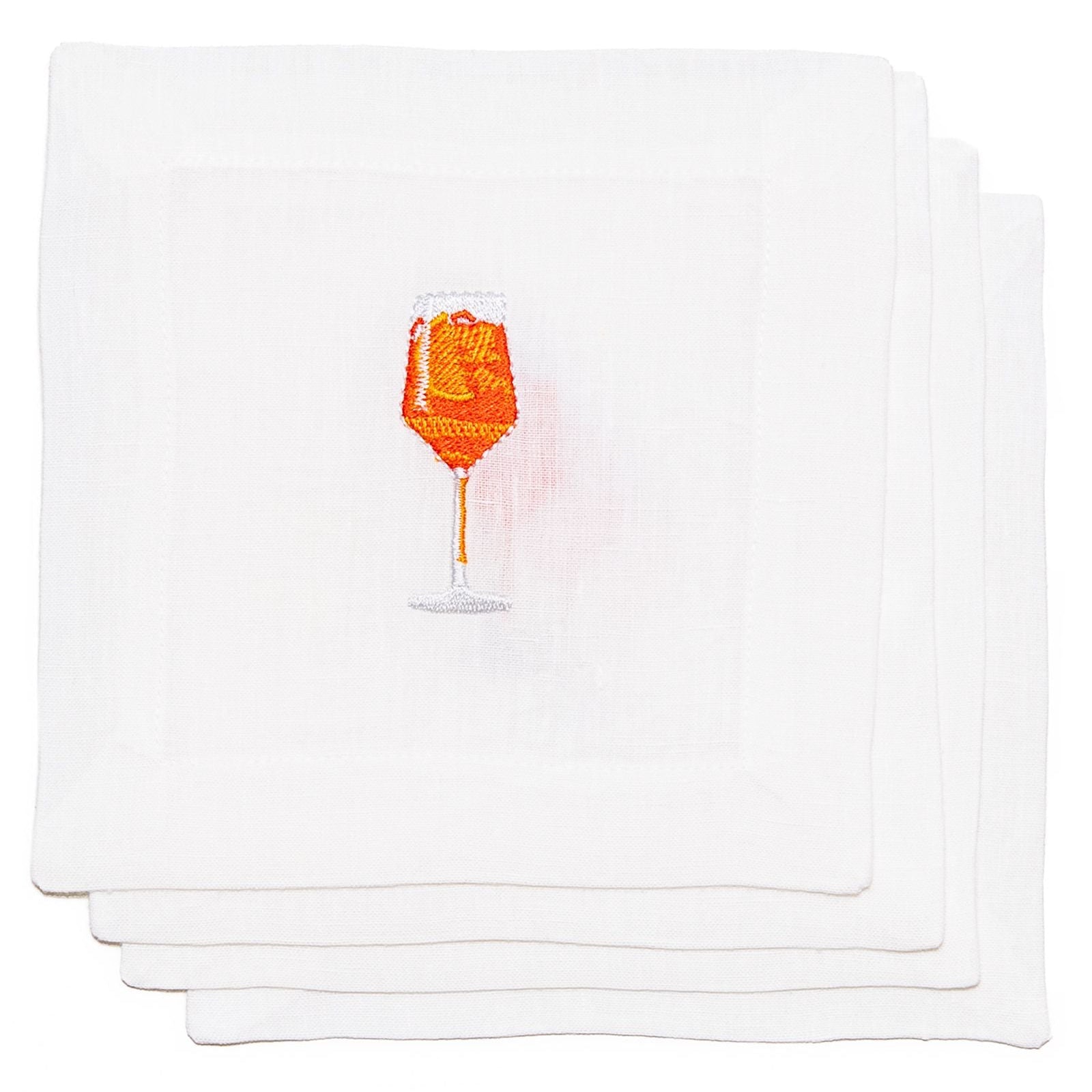 Set of white napkins with a small orange and pink design on a white background