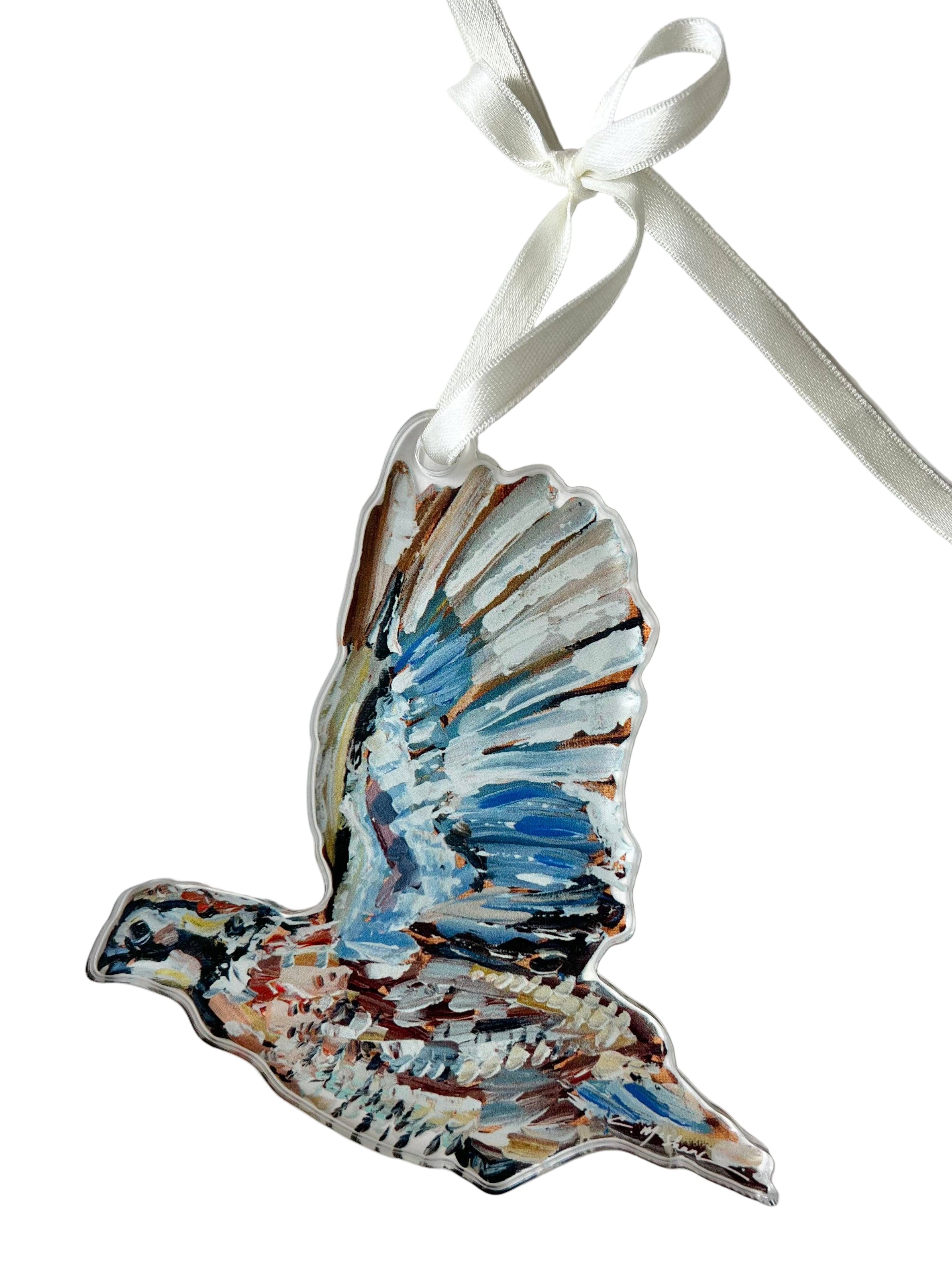 Decorative acrylic bird ornament with a white ribbon on a light gray background