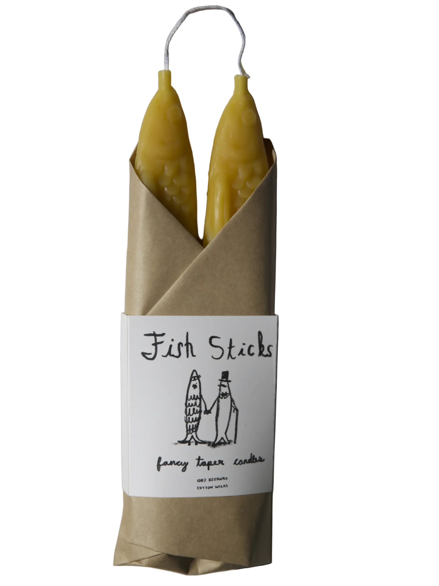 Two yellow candles in a brown paper wrap with a label on a gray background